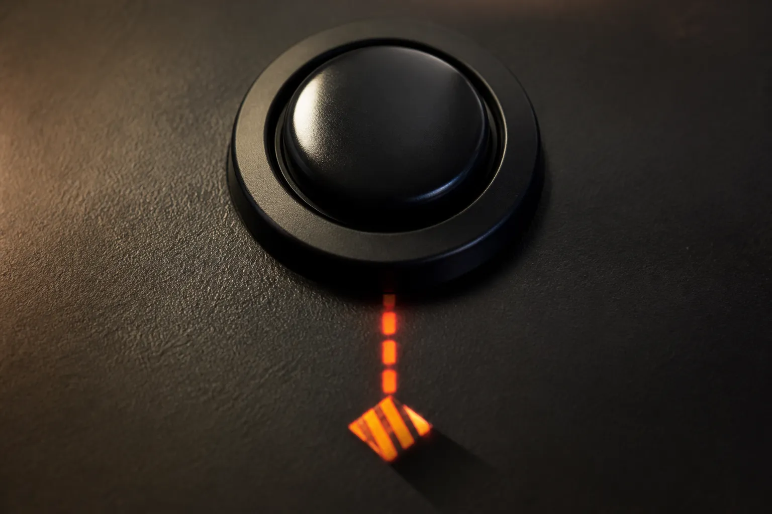 Close-up of a single black push button under warm light, with a faint glowing trail and a hazard shape beneath it, suggesting one press with a visible result.