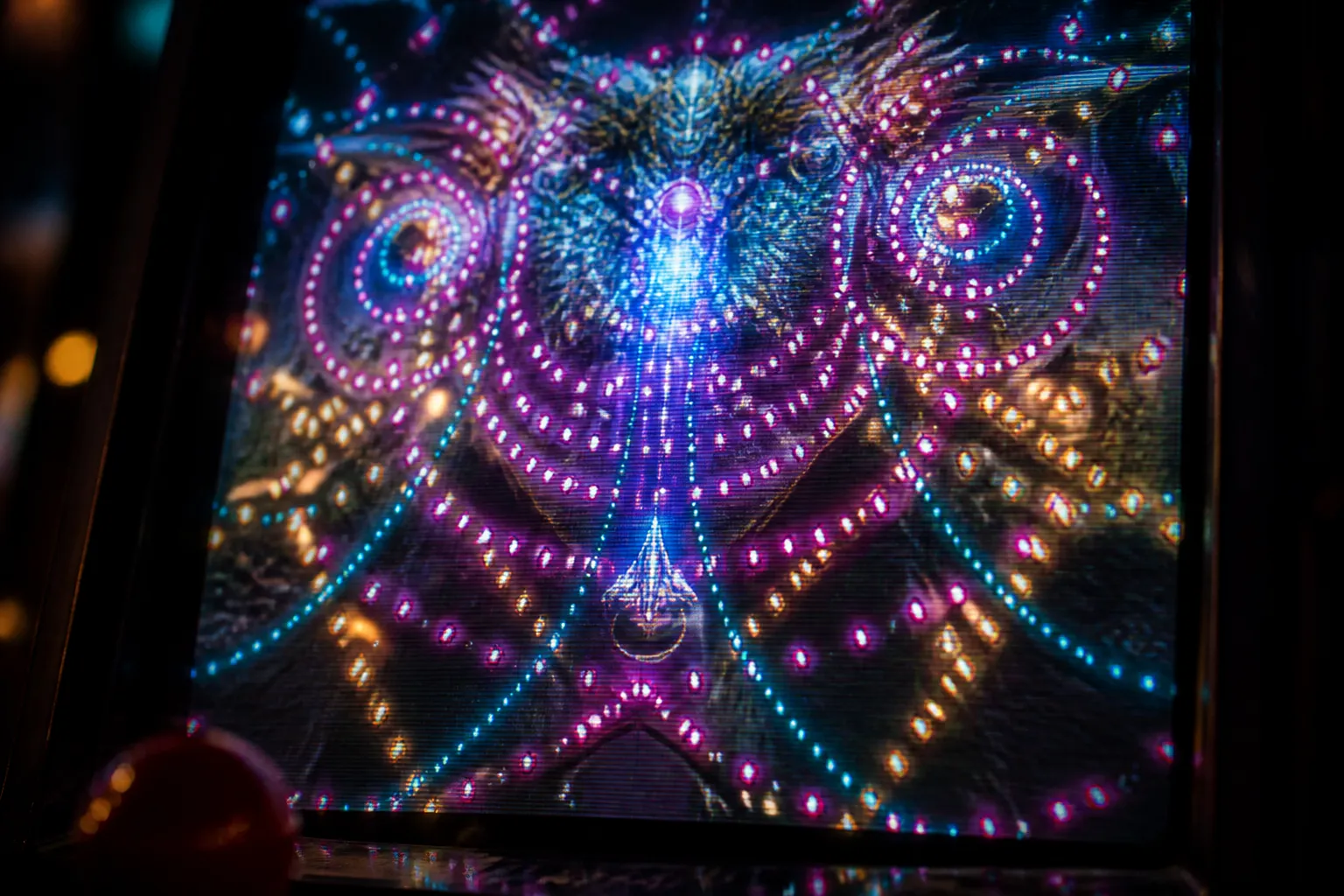 A crowded bullet hell screen filled with glowing patterns of shots, with a small ship's tiny hitbox marked in light against a much larger enemy sprite.